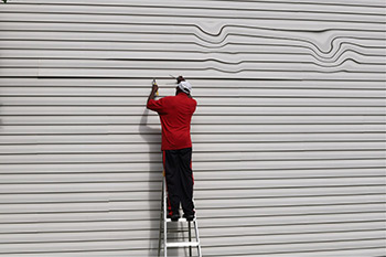 Melting vinyl siding being repaired.